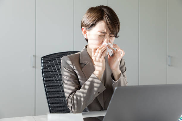 young asian woman blowing her nose. nasal inflammation. hay fever. - hay fever imagens e fotografias de stock