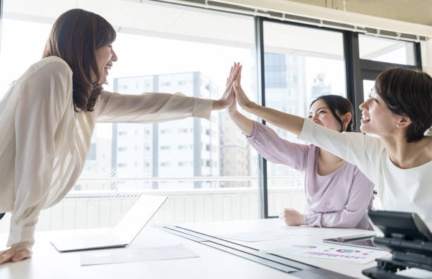istock Group of woman giving high five. 943327426