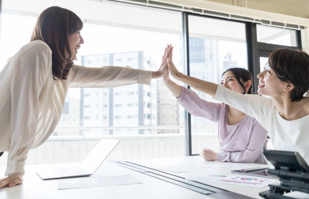 Group of woman giving high five. Group of woman giving high five. affirmative action photos stock pictures, royalty-free photos & images