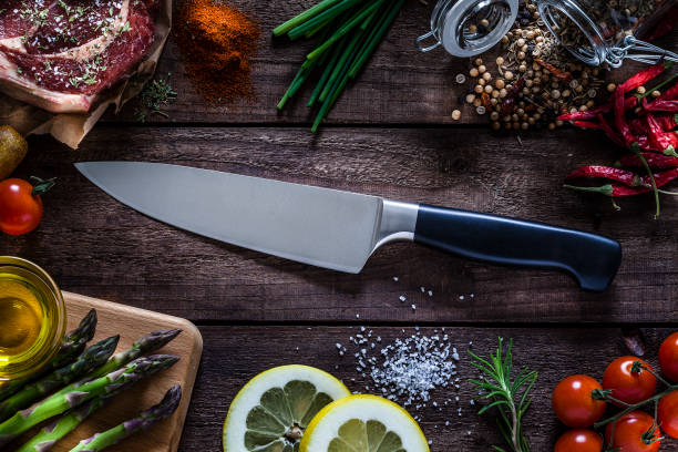 istock Kitchen knife shot on rustic wooden table 943331714