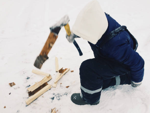 istock man chopping wood in winter 943338384