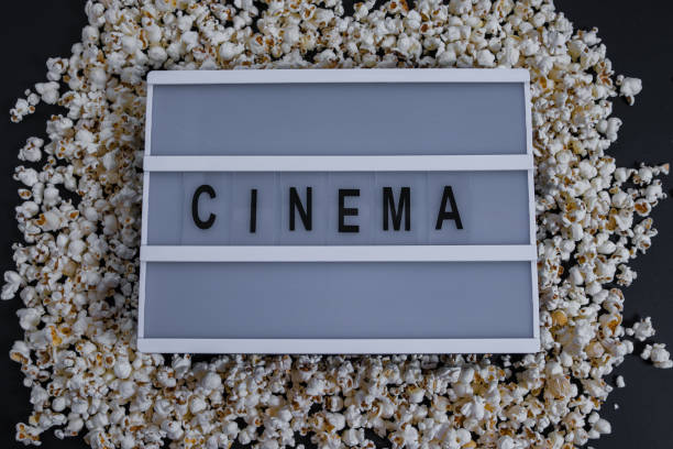 istock Top view Popcorn border on black with words Cinema 943347156