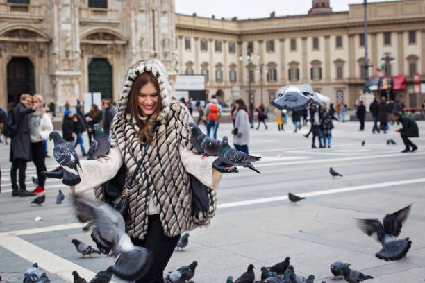 Woman playing with pigeons