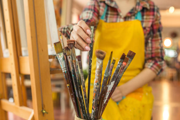 istock Woman choosing paintbrushes 943348912