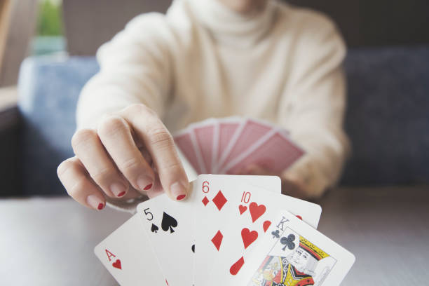 istock Woman playing cards 943351998