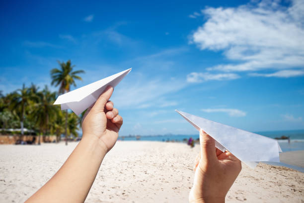 istock Hand holding rocket paper with sea background. concept freedom. 943358834
