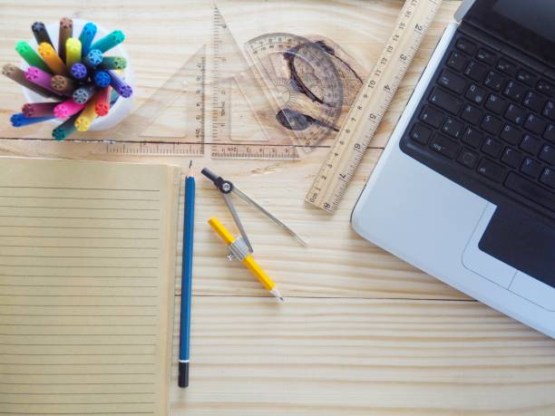 istock Computers, pencils, notebooks and drawing tools on wooden boards. Meaning of design work. New Graphic Creation and Concepts 943359350