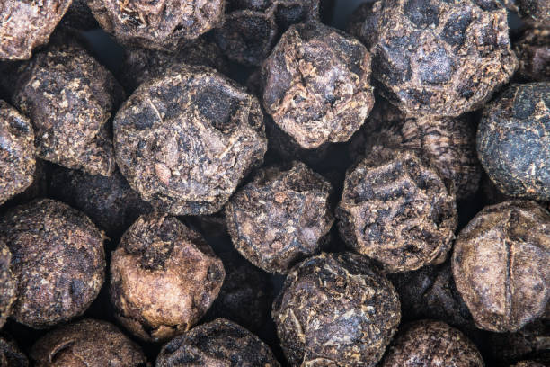 istock Close-up of black peppercorns as a decorative background. Piper nigrum 943364866