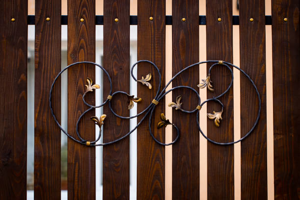 wooden gate with wrought iron elements close up stock photo
