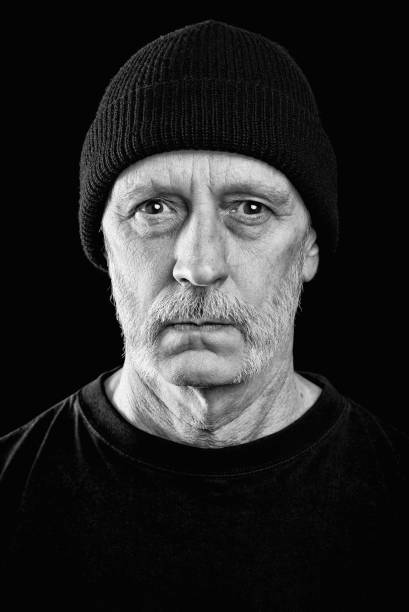 istock Dramatic black and white photo of a man with a beard and a woolen cap 943365144