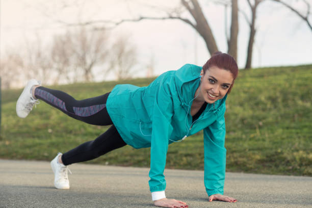 istock Young redhead woman exercising 943368458