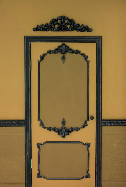 istock Old dramatic brown doors on the background of the wall. 943371918