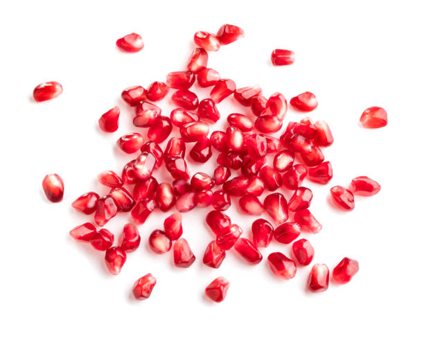 istock heap of pomegranate seeds isolated on white background 943372324