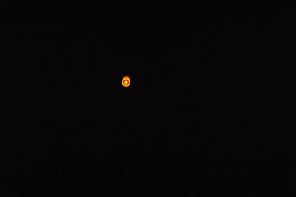 floating lantern or Yi Peng Lantern in the dark sky at night.