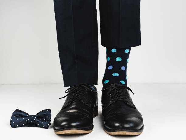 istock Stylish shoes, bright socks and bow tie 943388460