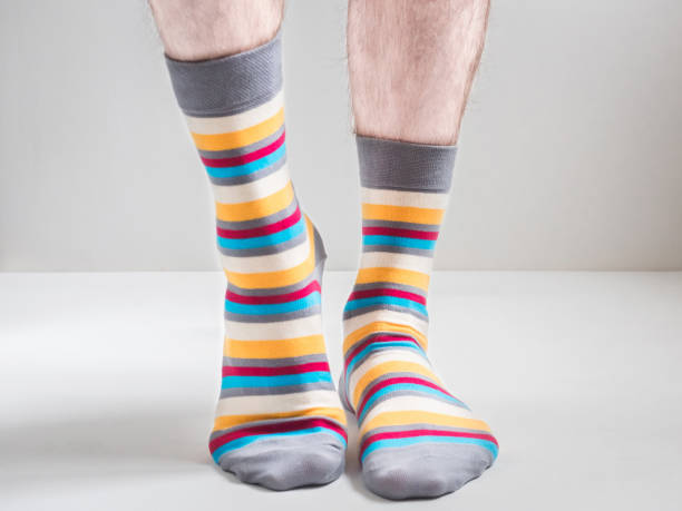 istock Men's feet in funny, colorful socks 943388508