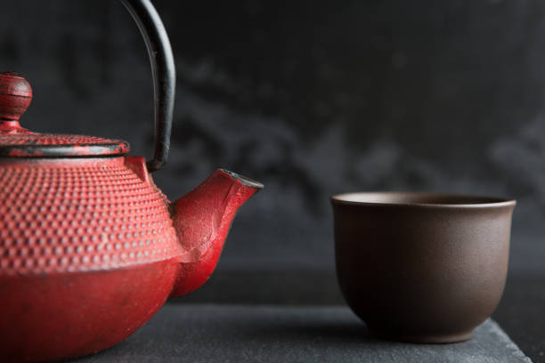 istock Red iron teapot on dark color background 943388588