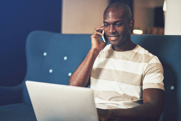 istock Young African entrepreneur talking on his cellphone and working online 943388684