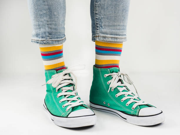 istock Stylish sneakers and funny, happy socks 943393742