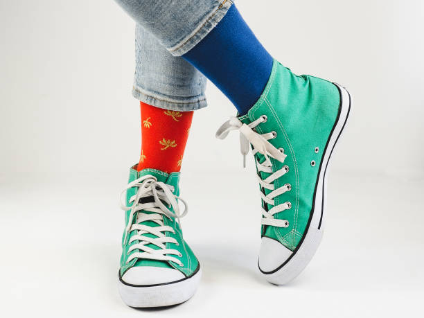 istock Stylish sneakers and funny, happy socks 943393758