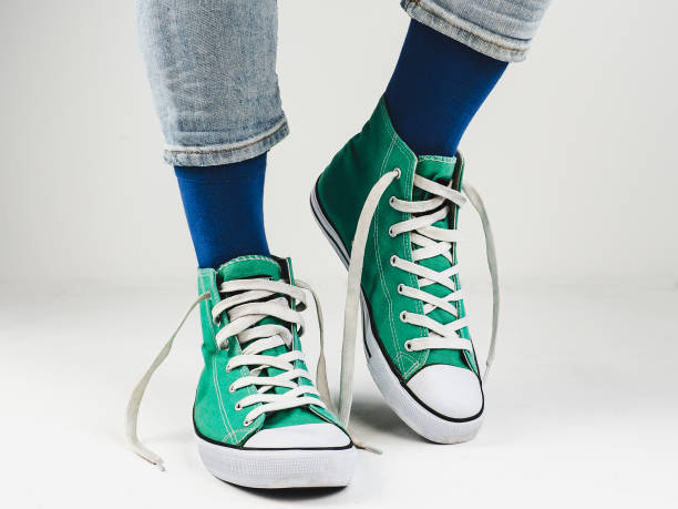 istock Stylish sneakers and funny, happy socks 943393788