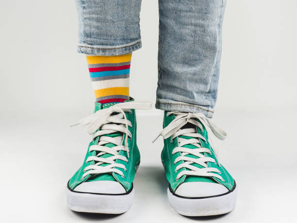 istock Stylish sneakers and funny, happy socks 943393824