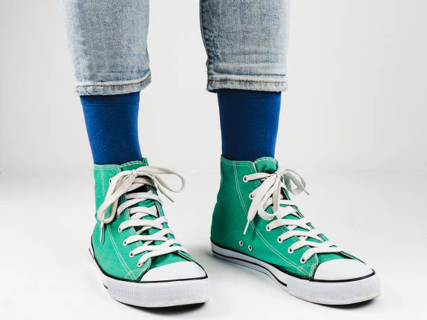istock Stylish sneakers and funny, happy socks 943393840