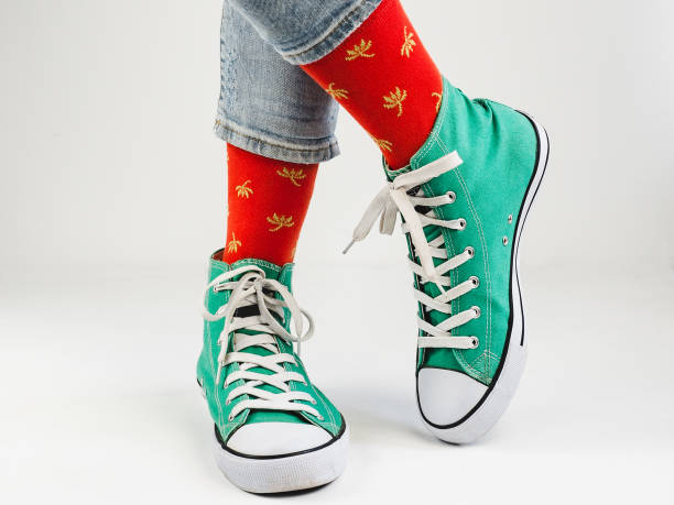 istock Stylish sneakers and funny, happy socks 943393862