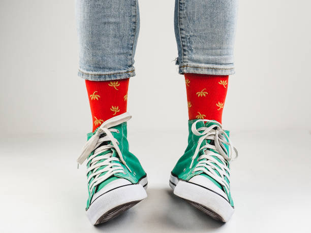 istock Stylish sneakers and funny, happy socks 943393902