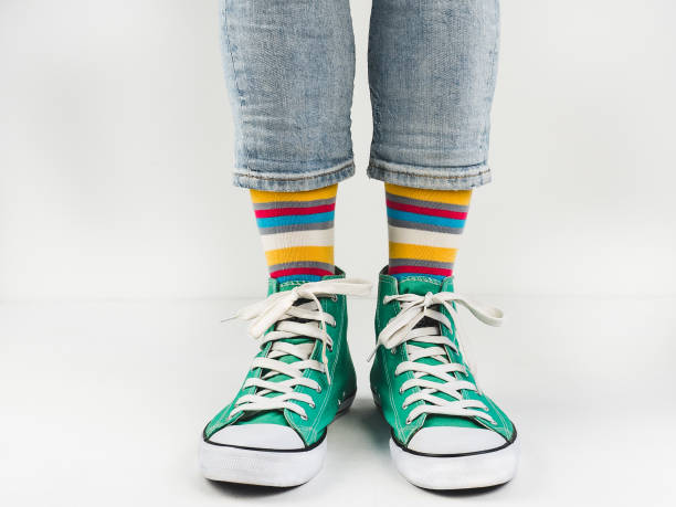 istock Stylish sneakers and funny, happy socks 943393910