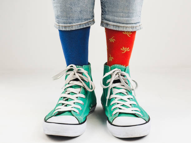 istock Stylish sneakers and funny, happy socks 943393930