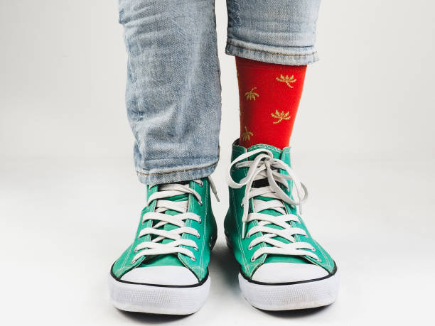 istock Stylish sneakers and funny, happy socks 943393980