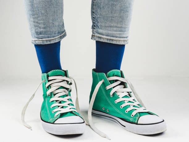istock Stylish sneakers and funny, happy socks 943393986