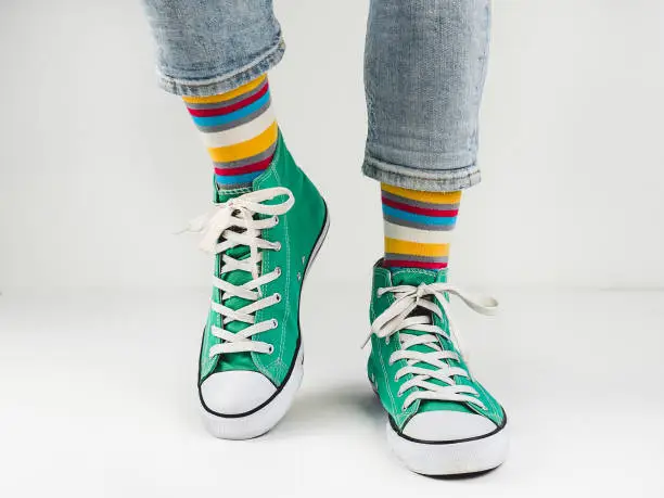 Photo of Stylish sneakers and funny, happy socks