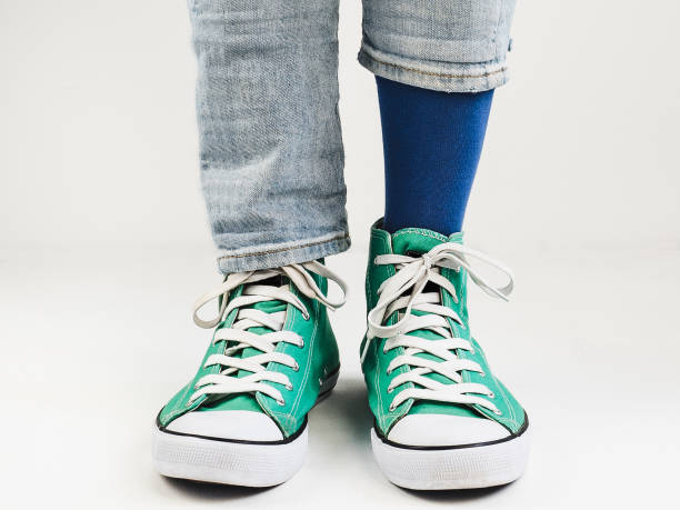 istock Stylish sneakers and funny, happy socks 943394030