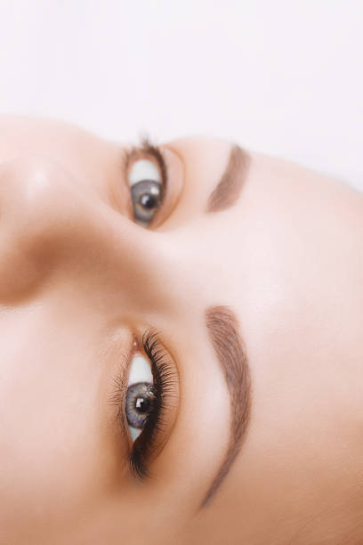 istock Eyelash Extension Procedure. Woman Eye with Long Eyelashes. Close up, selective focus 943394194