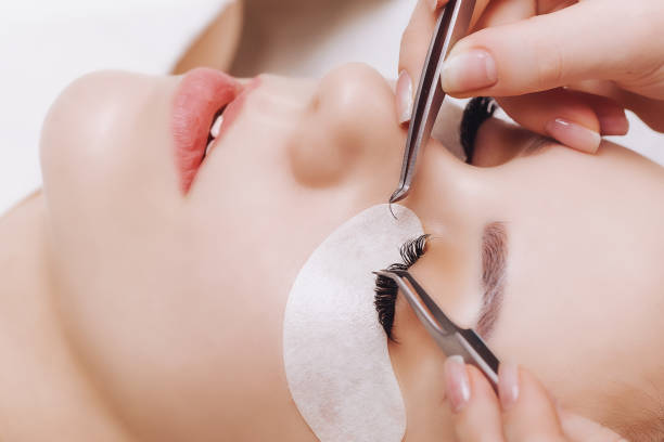 istock Eyelash Extension Procedure. Woman Eye with Long Eyelashes. Close up, selective focus 943394322