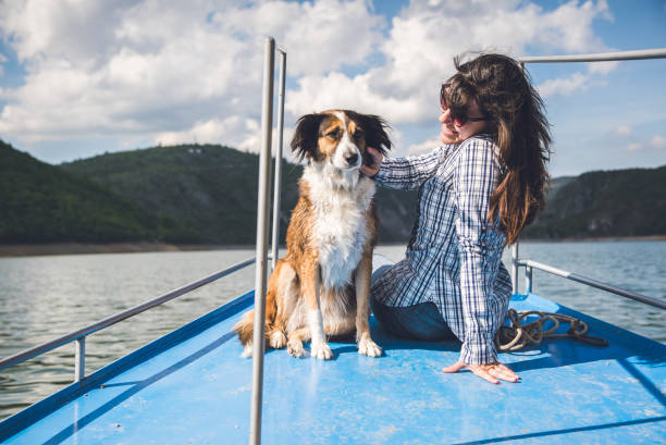 istock Woman enjoys a boat ride with dog. 943397492