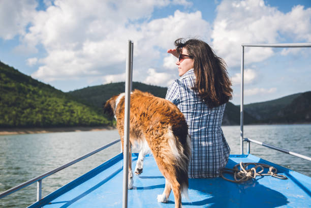 istock Woman enjoys a boat ride with dog. 943397962