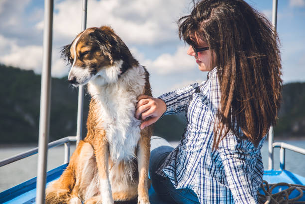 istock Woman enjoys a boat ride with dog. 943397994