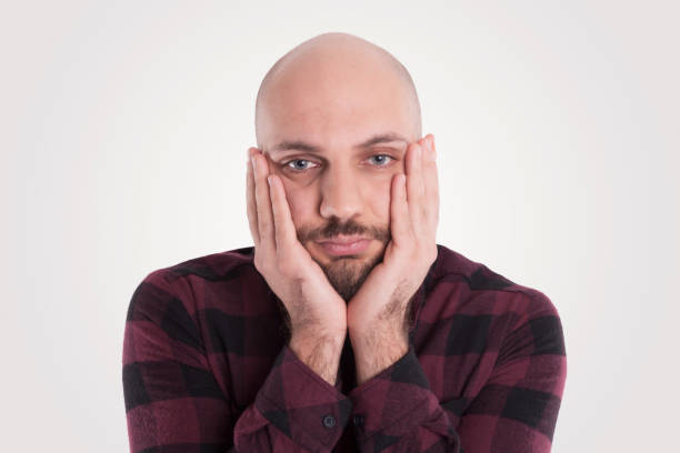 Bald Man Thinking With His Hands On Face Stock Photo - Download