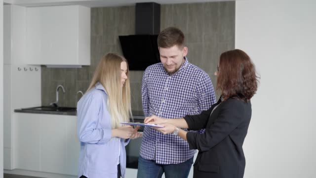 Husband and wife buying new modern apartment with beautiful interior