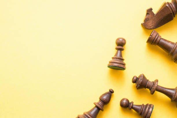 istock Chess game figures on yellow background , top view, flat lay copy space 943404832