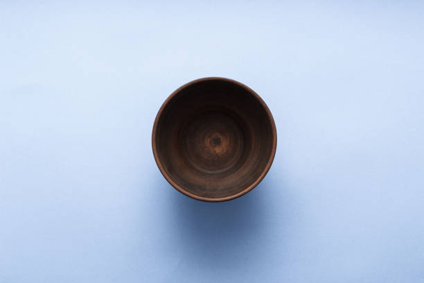 istock Empty brown plate on pastel blue background, top view, flat lay 943405272