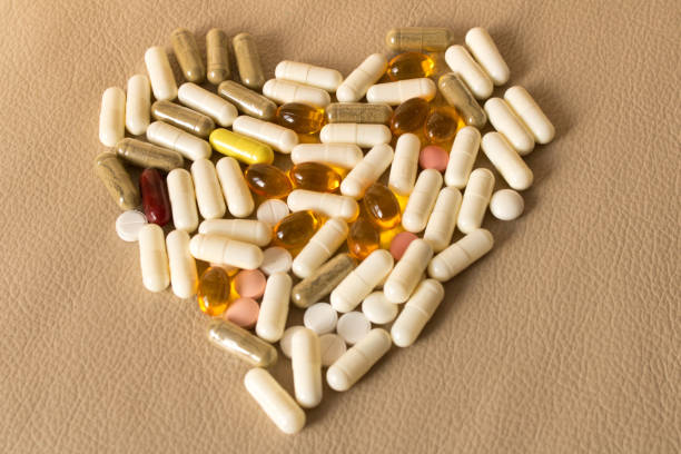 istock Many colored pills scattered on a beige background 943405658