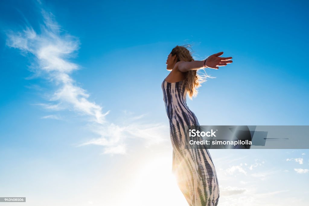 Young beautiful woman open arms for life. Independent moment and lifestyle Young nice woman enjoy her freedom opening arms. Independent life and great feel with the world. Embrace all with satisfaction. Tenerife soul. Women Stock Photo