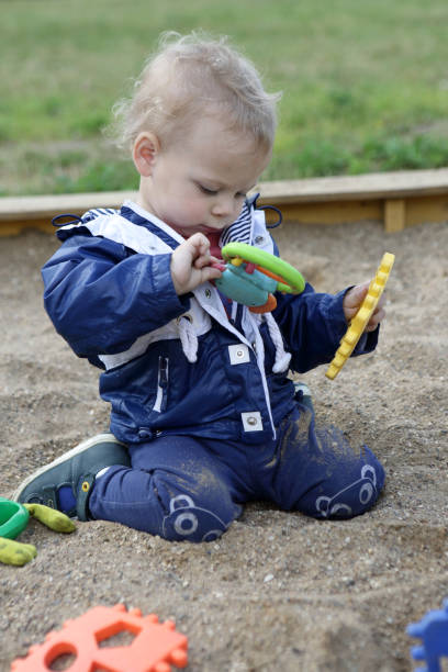 istock Toddler playing in sandbox 943411482