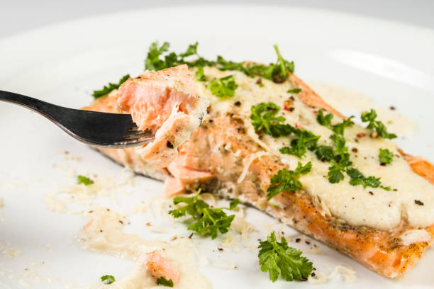 istock Fried Salmon with cheese sauce, parsley and pepper. 943418112