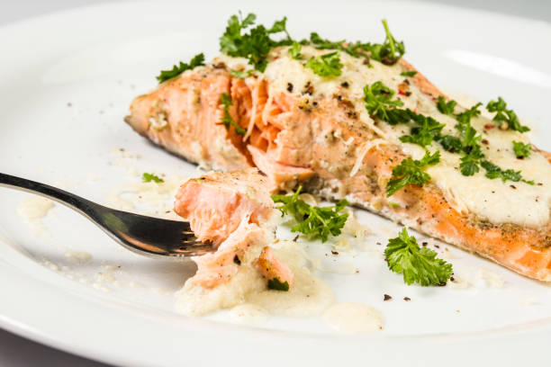 istock Fried Salmon with cheese sauce, parsley and pepper. 943418658