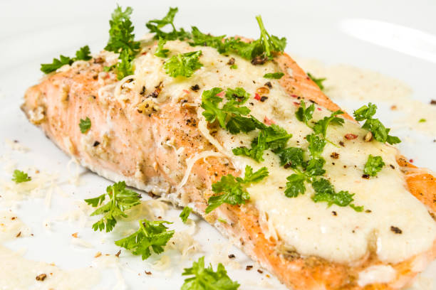 istock Fried Salmon with cheese sauce, parsley and pepper. 943421826
